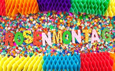 Rosenmontag,In,Colorful,Wooden,Characters,On,Background,Made,Of,Confetti Rosenmontag,In,Colorful,Wooden,Characters,On,Background,Made,Of,Confetti